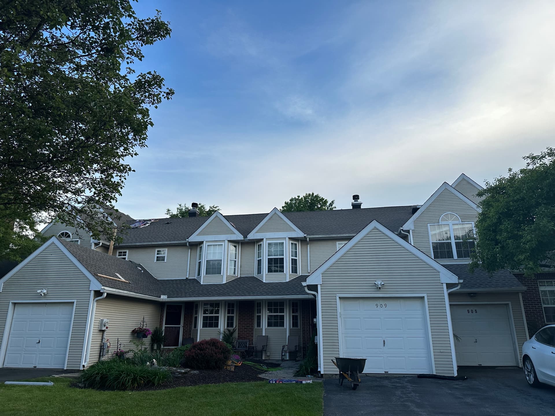 Completed charcoal asphalt shingle roof on a townhome