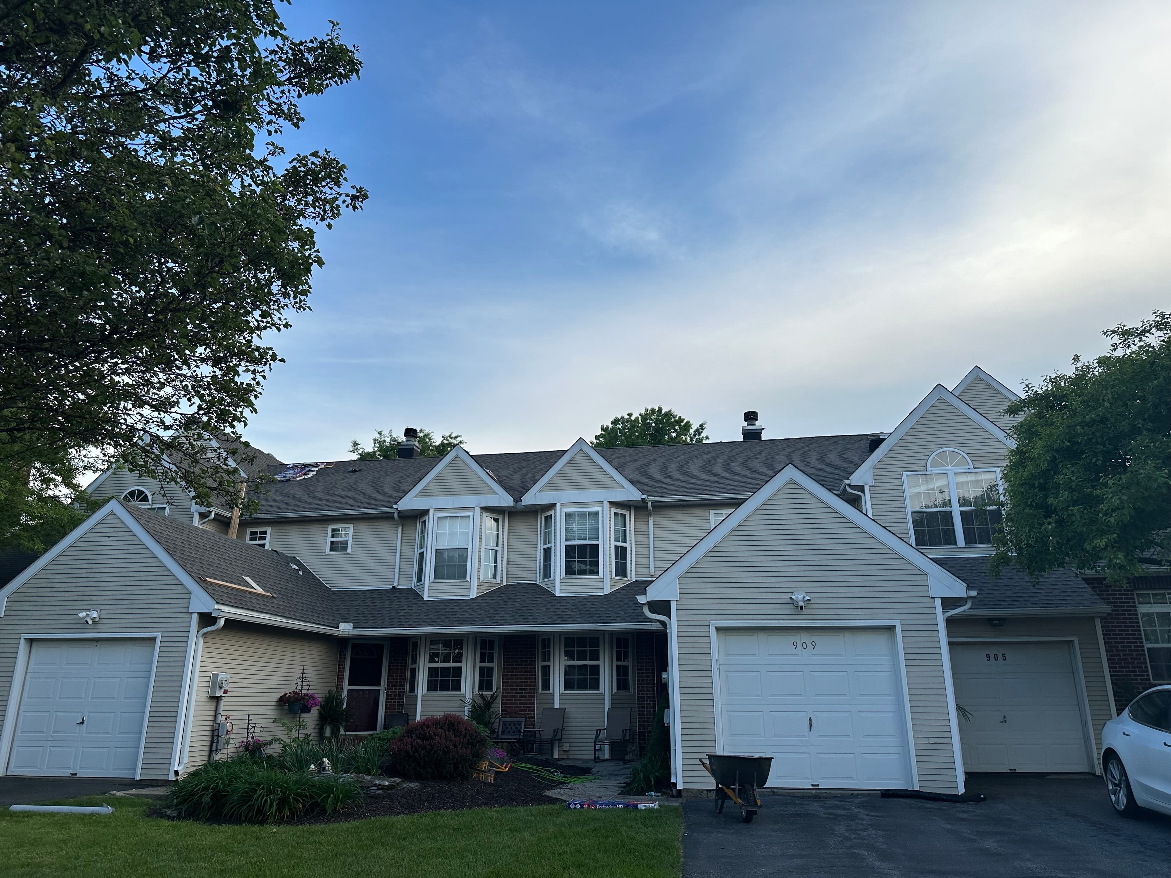 Completed charcoal asphalt shingle roof on a townhome