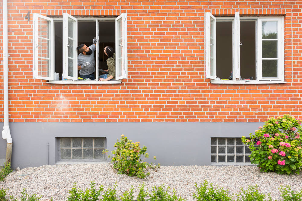 Couple checking window frame during renovation
